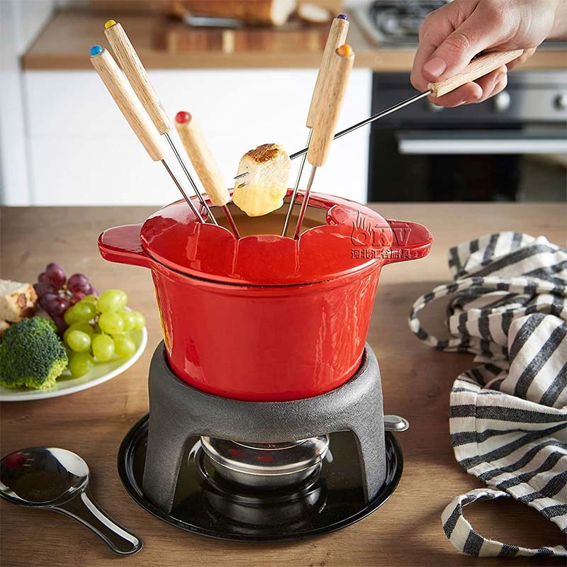 OKV Mini Hot Pot Enamelled Cast Iron Pot Malatang Skewer Hot Pot Set STURDY CAST IRON fondue pot can be heated on a gas or electric stove. Cast iron pot holds and radiates heat efficiently when hot, keeping your fondue melted. All accessories are included, including a heat-resistant enamel-coated cast iron pan, cast iron stand, 6 stainless steel forks, rubber wood base plate and chrome-plated gel fuel burner. Available in an array of bright colors including red, blue, white, and orange, this fondue set has a cheerful presence that suits its inviting, communal purpose.